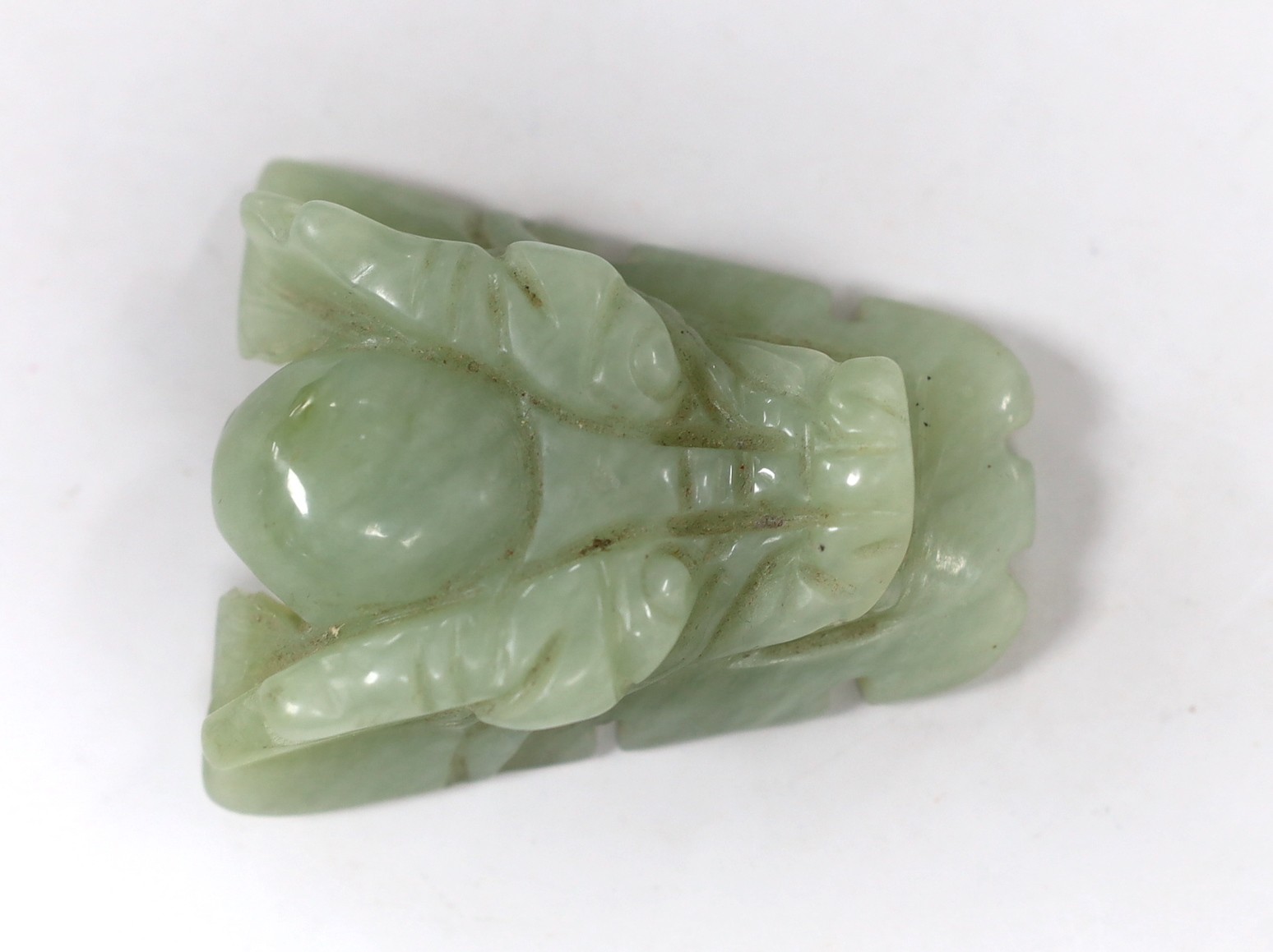 A Chinese bowenite jade dragon’s head belt buckle. 7cm wide